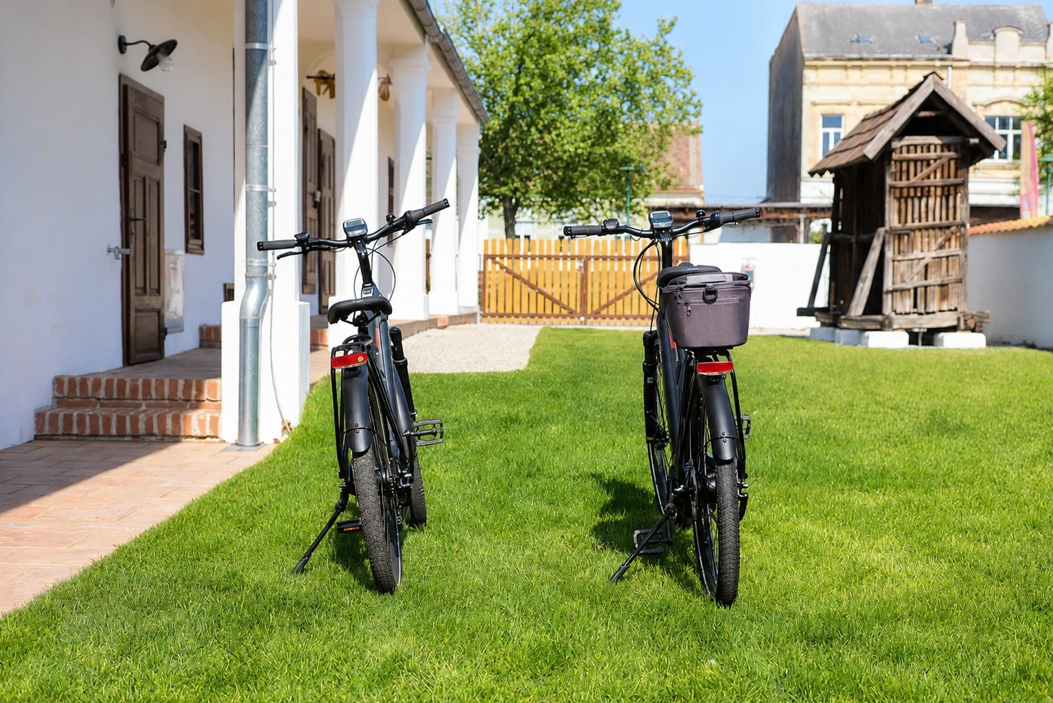 Zwei hofeigene Fahrräder stehen im sonnigen Innenhof des Tschardakenhofs in Lutzmannsburg für den Urlaub ohne Auto bereit.